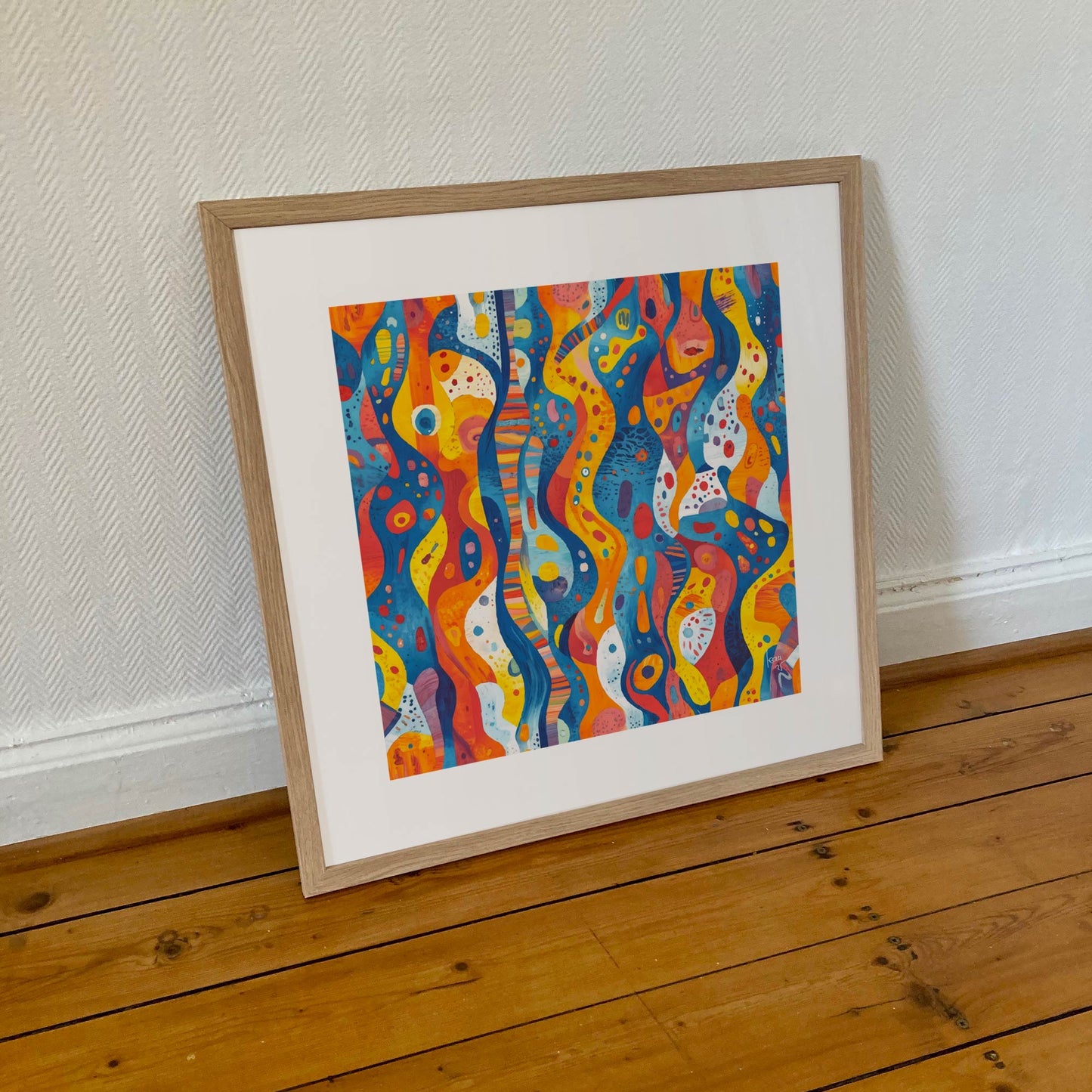 Tirage encadré 50×50 cm de l’œuvre "Coraux", composition organique colorée évoquant les récifs, dans un cadre sobre et élégant.