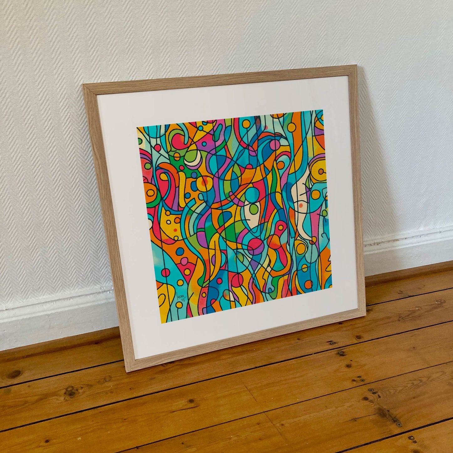 Tirage encadré 50×50 cm de 'Capsules', œuvre abstraite colorée aux formes rondes et dynamiques, présentée dans un cadre moderne sobre.