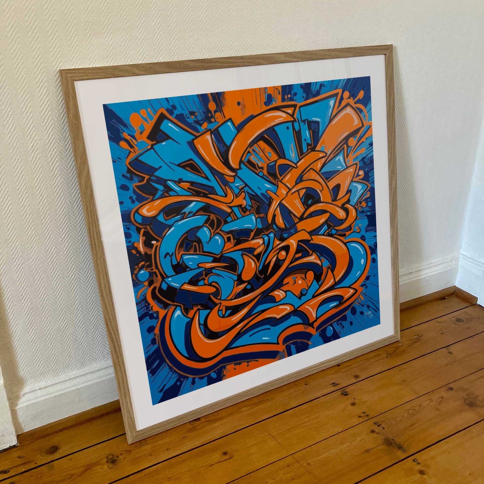 Œuvre 'EXPLOSION' encadrée en 70x70cm, motifs orange et bleu dans un cadre en bois clair avec verre acrylique, style street art abstrait, 2024
