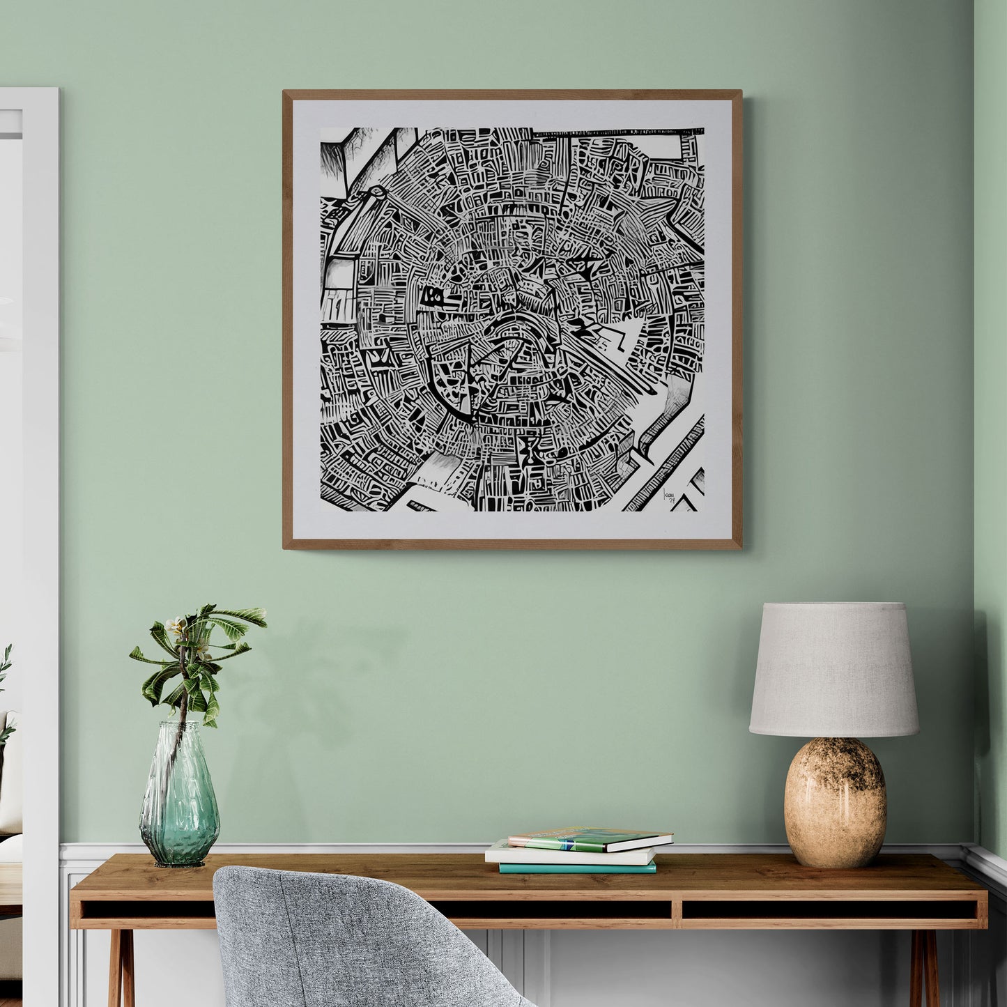 Mise en situation de l’œuvre "Matrice" encadrée dans un bureau contemporain, affichée sur un mur blanc, mettant en valeur son style graphique noir et blanc sophistiqué.