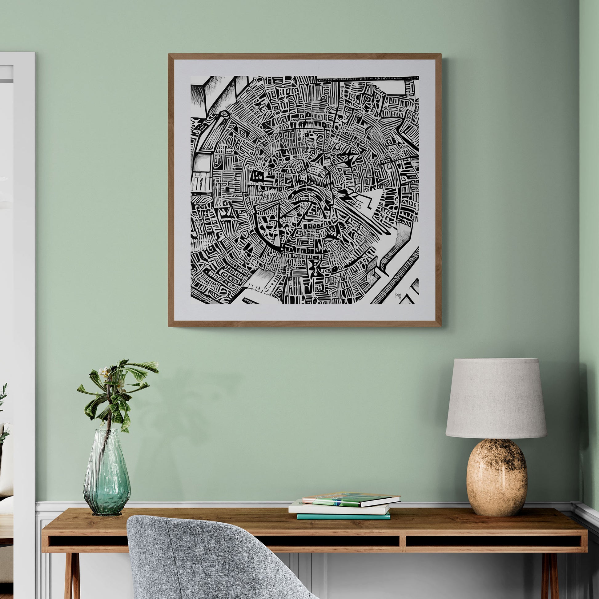 Mise en situation de l’œuvre "Matrice" encadrée dans un bureau contemporain, affichée sur un mur blanc, mettant en valeur son style graphique noir et blanc sophistiqué.