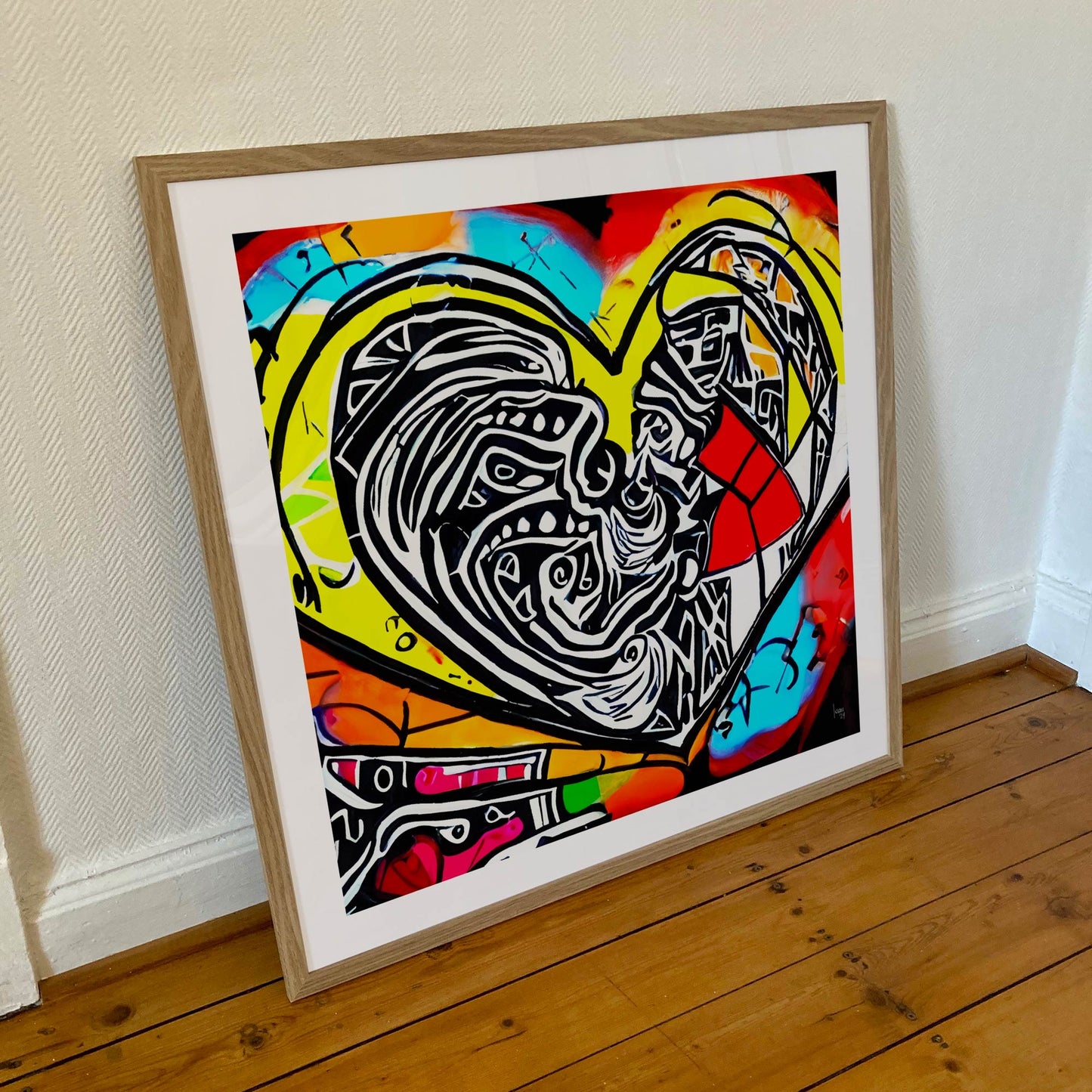 Œuvre 'Espoir' encadrée format 70×70 cm, cœur puissant noir, blanc, rouge, jaune, bleu et orange